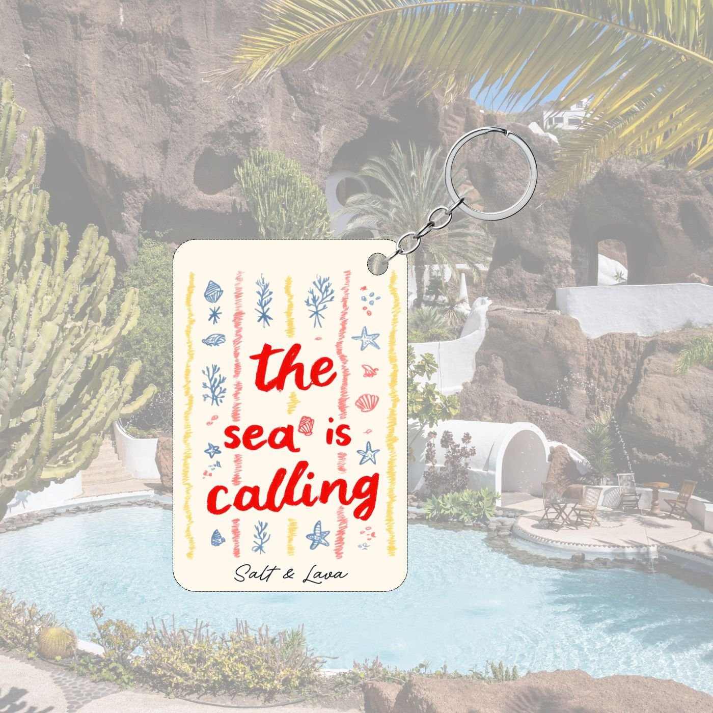 Cream keychain with hand-drawn stripes, shells and seaweed and the words the sea is calling in red